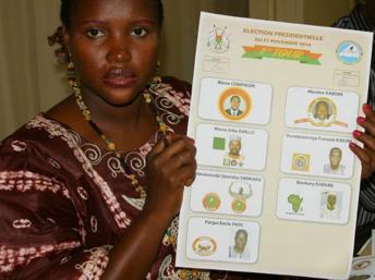 Une employée de la commission électorale montre la liste des candidats à l'élection présidentielle au Burkina Faso. Ouagadougou, le 21 novembre 2010. Ahmed Ouoba / AFP