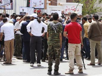 Des miliciens réclamant une « épuration » de l’administration ont encerclé le ministère des Affaires étrangères libyen, à Tripoli, ce dimanche 28 avril. REUTERS/Stringer