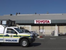 A Durban, un véhicule de police stationne devant une usine Toyota en grève, le 20 août 2013. REUTERS/Rogan Ward