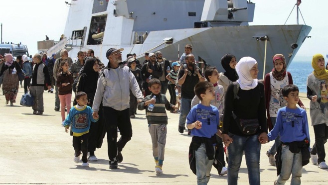 Des migrants débarquent dans le port d'Augusta en Sicile après avoir été secourus par un navire militaire, le 22 mai 2014.