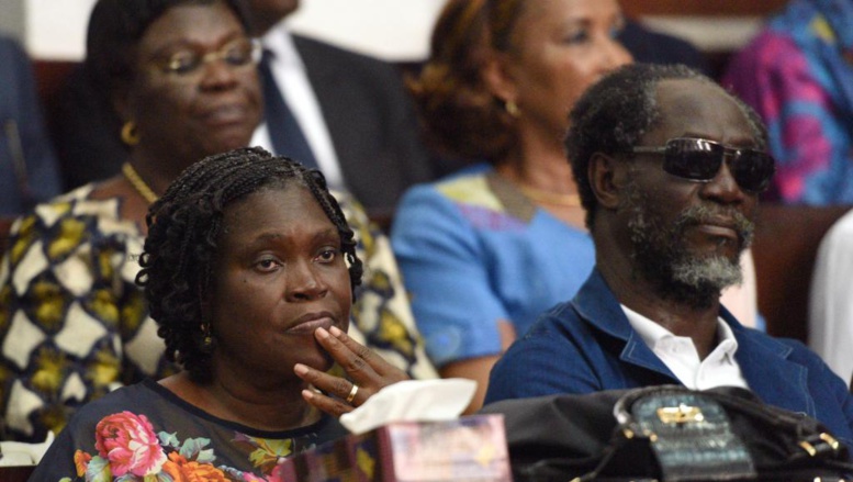 L'audience de ce 26 décembre a été l'occasion de voir Simone Gbagbo, pour la première fois depuis son arrestation avec son époux en avril 2011. A ses côtés, se tient l'ancien Premier ministre Gilbert Ake N'Gbo, également poursuivi. AFP PHOTO / SIA KAMBOU