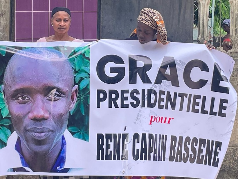 Sur cette photo prise dans leur quartier de Kandialang, à Ziguinchor, Odette Victorine Coly, épouse de Bassène tient une banderole demandant la grâce présidentielle pour son mari