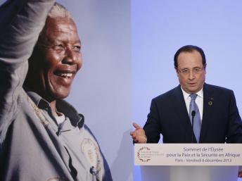 Devant un portrait géant de Nelson Mandela, François Hollande prononce son message d'ouverture du sommet de l'Elysée, le 6 décembre 2013. REUTERS/Yoan Valat/Pool