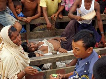 Evacuation de blessés après l'attaque du camp des déplacés Rohingyas à la périphérie de la ville de Sittwe dans l'Etat Rakhine, le 9 Août 2013. AFP PHOTO / STR