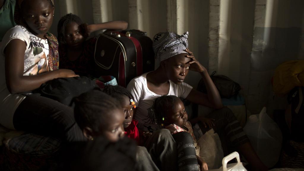 A Bangui, des femmes et des enfants se cachent dans un contener en attendant d'être évacués vers la frontière camerounaise.